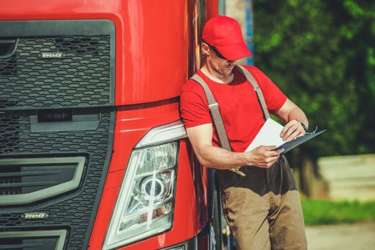 camionero con un camión rojo